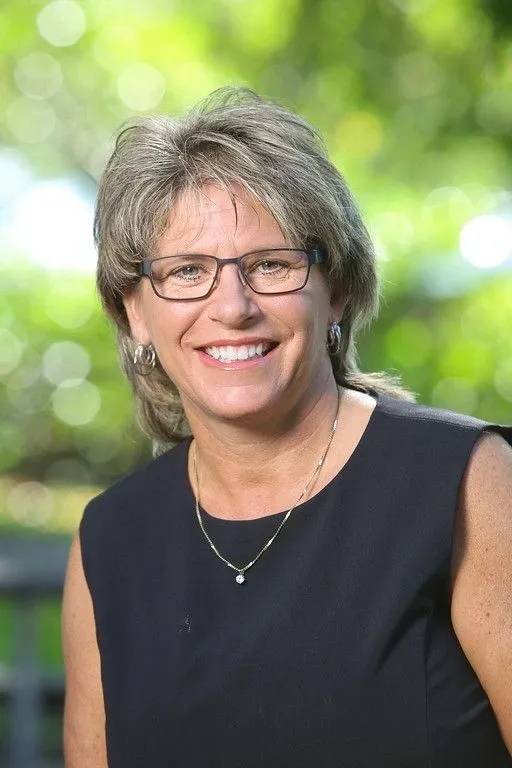 A woman with glasses and a black shirt