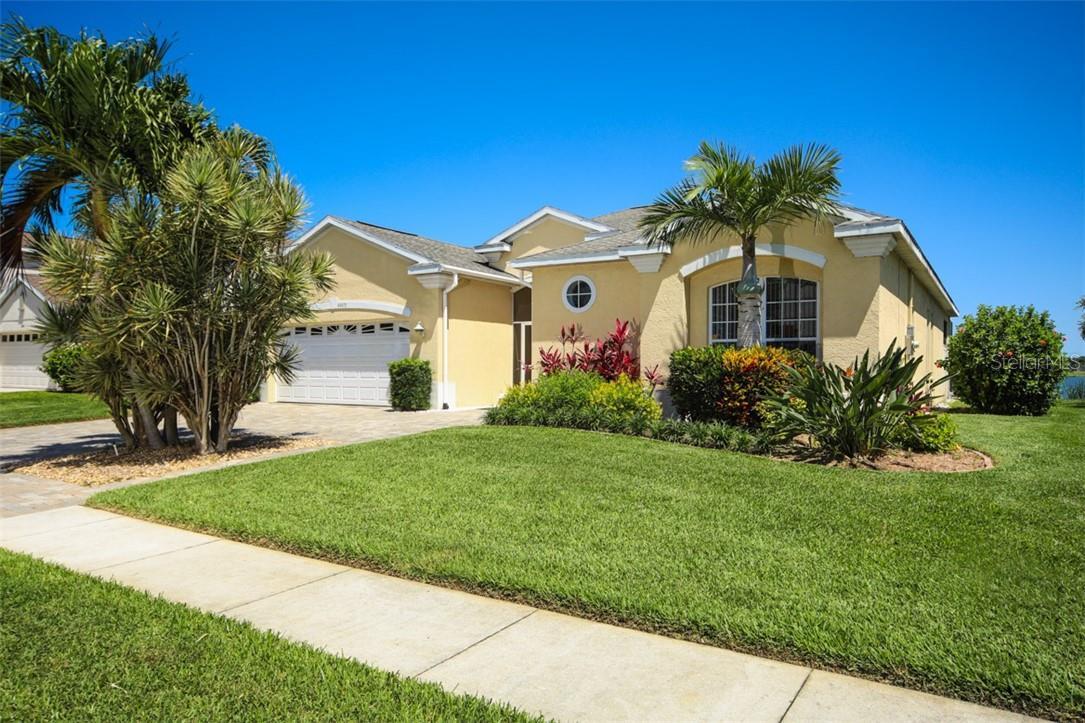 A house with grass and trees in front of it.